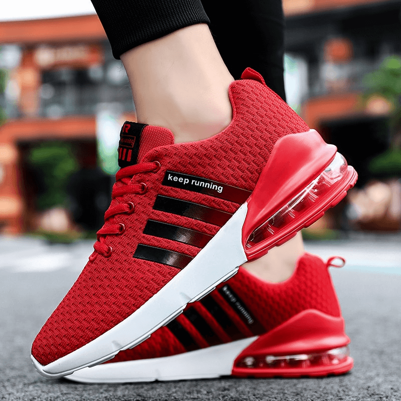 Fashionable red running sneakers with breathable mesh and cushioned soles, perfect for comfort and style on the go!